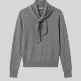 A heather gray knit sweater with a scarf detail