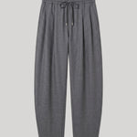 A pair of dark gray pleated knit pants