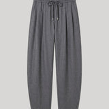 A pair of dark gray pleated knit pants