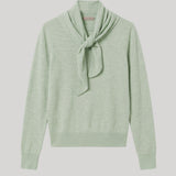 A light sage green knit sweater