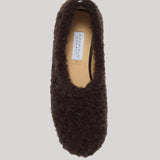 A top view of a fuzzy brown cashmere slipper shown on a plain grey background