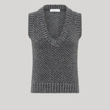 A sleeveless knit sweater vest with a V-neck and a gray and black herringbone pattern, from Gabriela Hearst, shown against a solid light gray background.