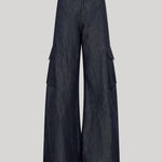 Dark blue wide-leg cargo pants made of denim-like fabric, featuring large flap side pockets, from Gabriela Hearst, shown against a solid light gray background.