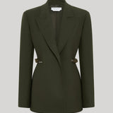 An olive green single-breasted blazer with structured shoulders and decorative gold-tone chains on the waist, from Gabriela Hearst, displayed on a neutral light gray background.
