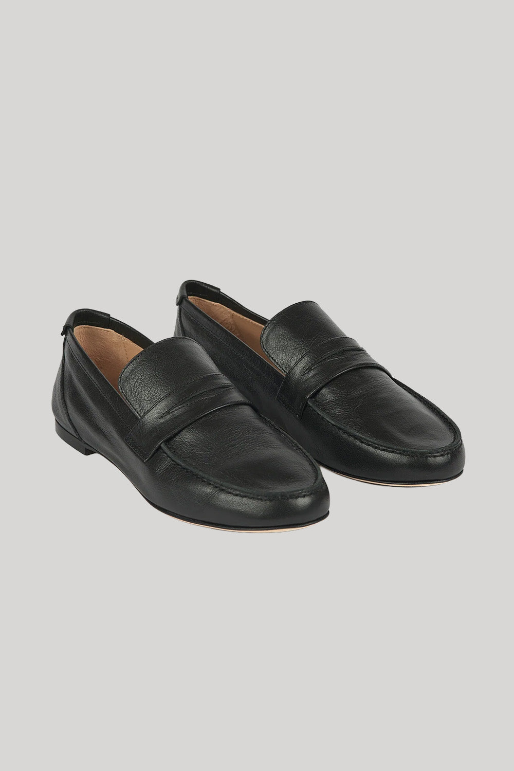 A pair of black leather penny loafers with a smooth finish, displayed on a solid light gray background.