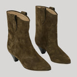 A pair of women's mid-calf ankle boots in dark olive suede, featuring a low block heel, pointed toe, and a pull tab at the back of the shaft, shown against a solid light gray background.