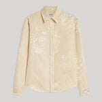 A light beige long-sleeve button-up shirt with a subtle tonal floral jacquard pattern from Jil Sander. Displayed flat against a neutral gray background.