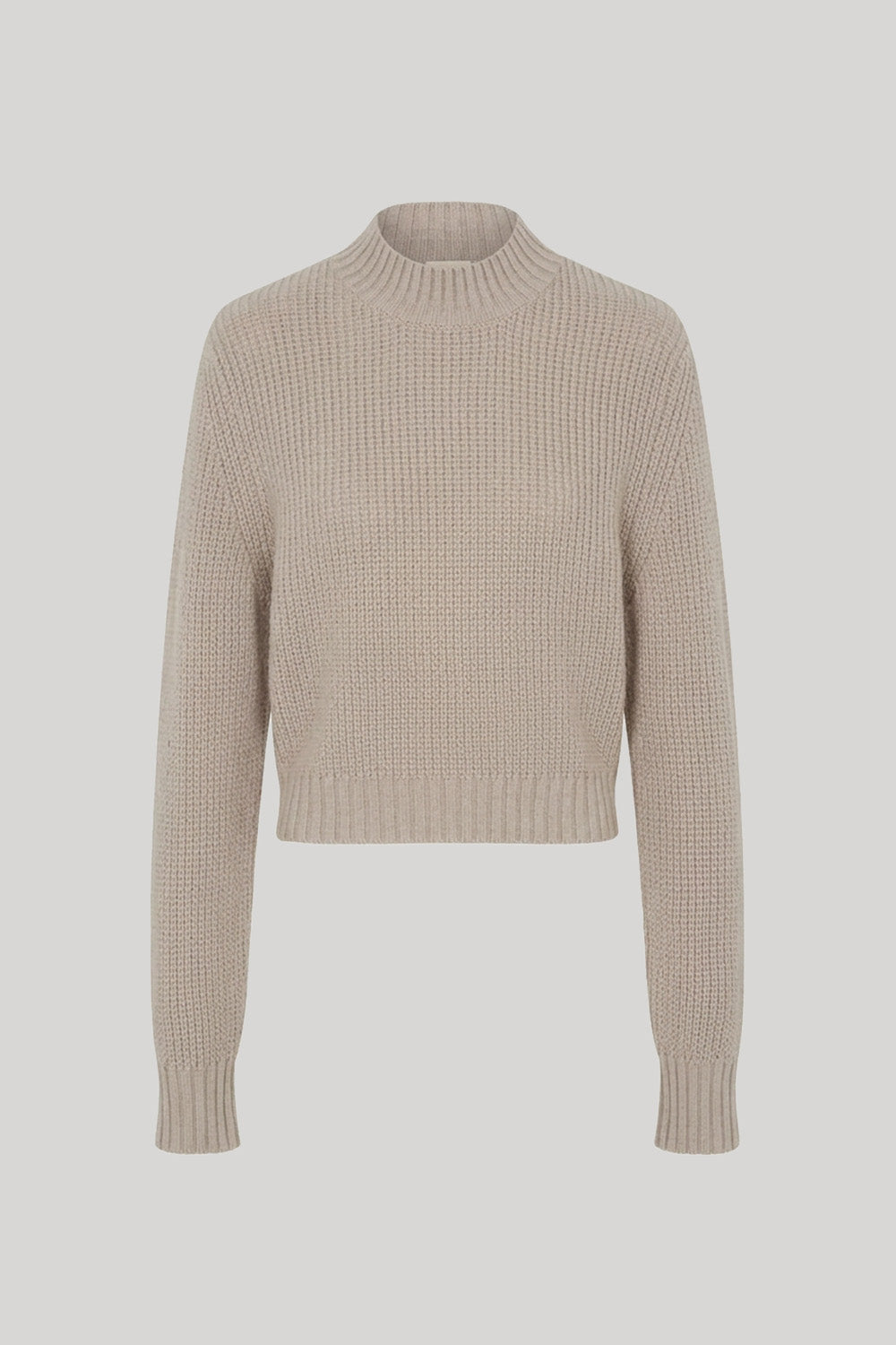 A cropped, long-sleeve knit sweater in beige
