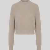 A cropped, long-sleeve knit sweater in beige