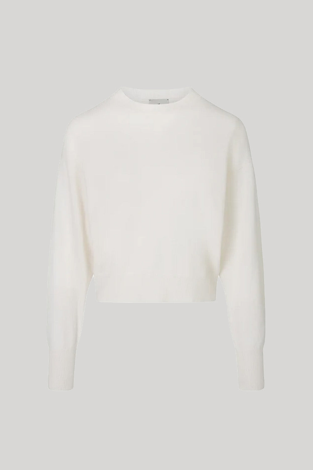 A white long-sleeve knit sweater