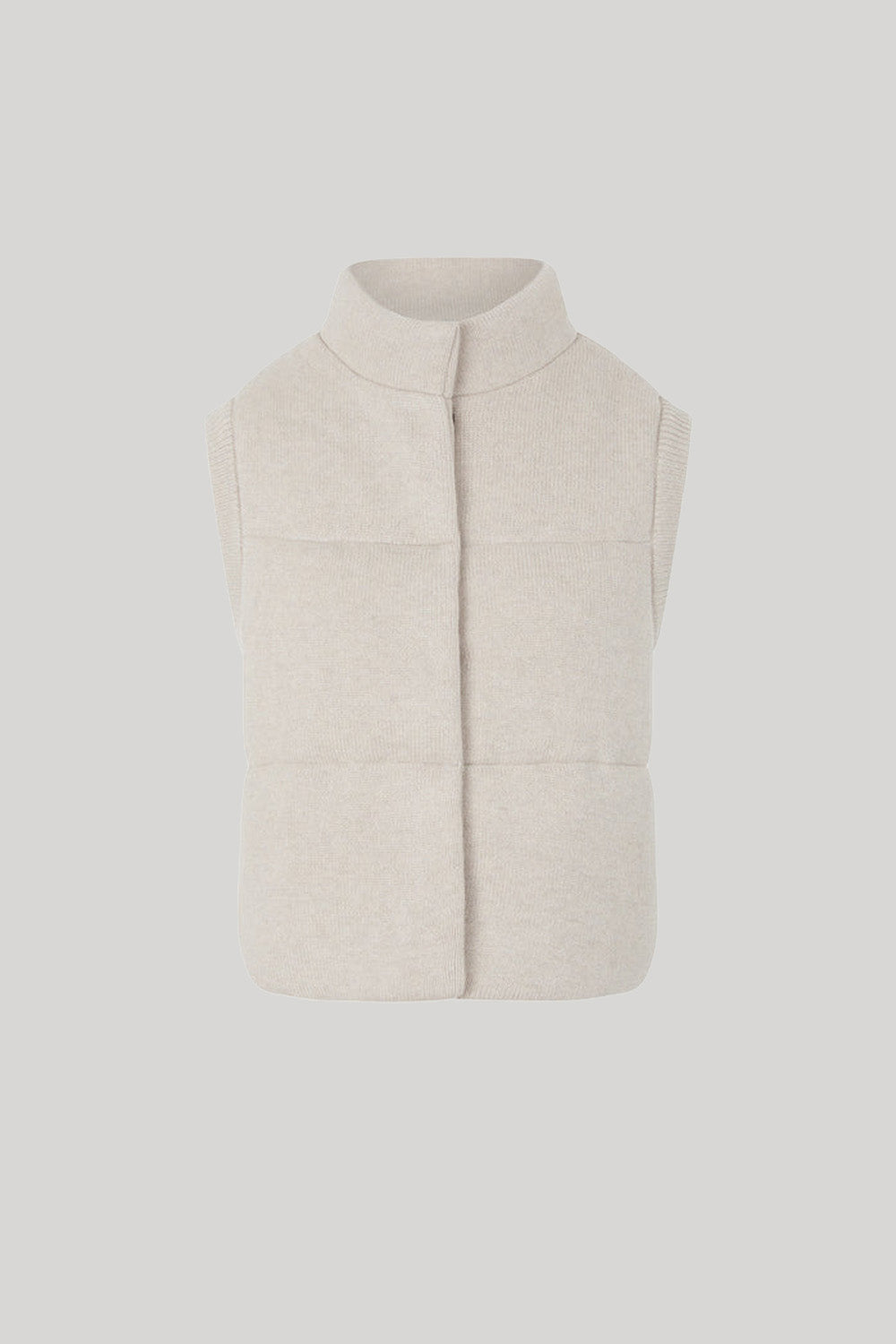 A sleeveless, quilted knit vest in a light cream 