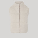 A sleeveless, quilted knit vest in a light cream 