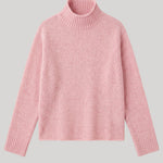A light pink knit turtleneck sweater