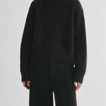 Black turtleneck sweater with back cutout