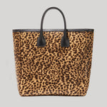 A leopard print tote bag with black handles and black trim, from Nili Lotan, shown against a solid light gray background.
