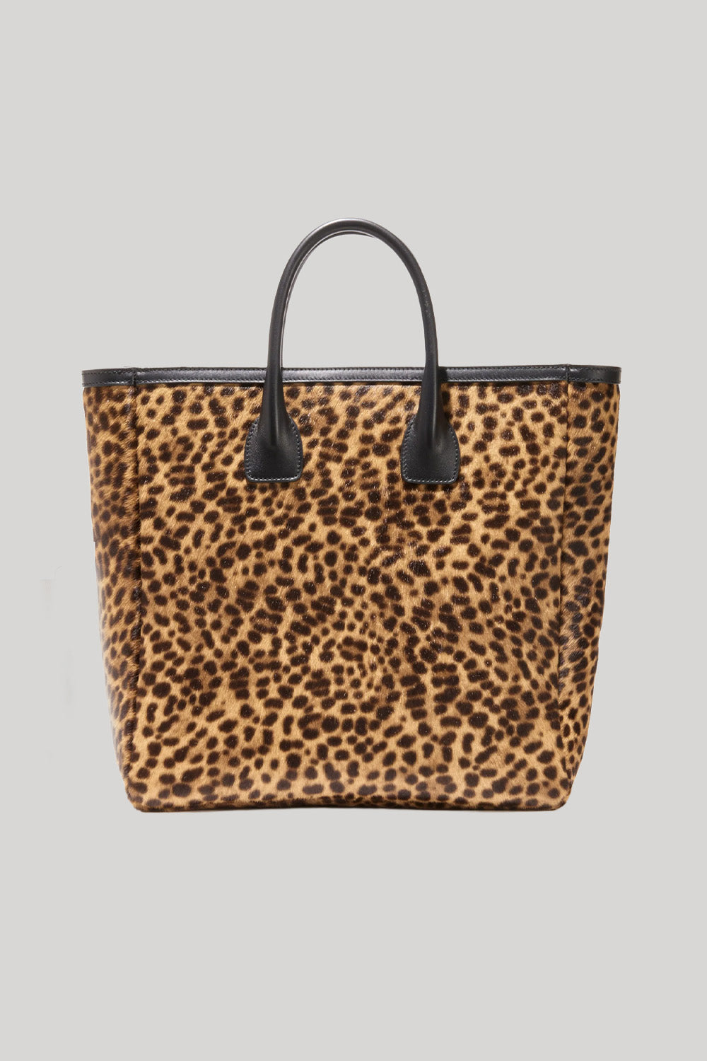 A leopard print tote bag with black handles and black trim, from Nili Lotan, shown against a solid light gray background.