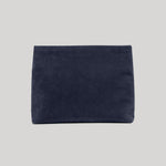 A dark navy blue suede or velvet pouch bag from Nili Lotan shown flat against a solid light gray background.