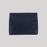 A dark navy blue suede or velvet pouch bag from Nili Lotan shown flat against a solid light gray background.