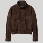 A dark brown suede jacket with a high stand-up collar, buttoned front, and two large flap pockets on the chest, displayed against a solid light gray background.