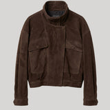 A dark brown suede jacket with a high stand-up collar, buttoned front, and two large flap pockets on the chest, displayed against a solid light gray background.
