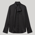 A black long-sleeve blouse with a high collar and a bow detail