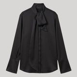 A black long-sleeve blouse with a high collar and a bow detail