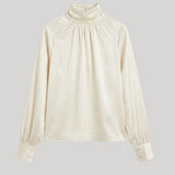 An off-white satin blouse 