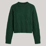 A dark green cropped cable-knit sweater