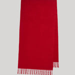 A bright red rectangular scarf with fringed edges, displayed flat against a solid light gray background.