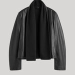 A black leather jacket with a draped, open-front design, displayed on a neutral light gray background.