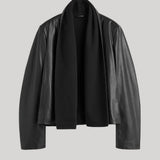 A black leather jacket with a draped, open-front design, displayed on a neutral light gray background.