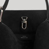 Close-up of the interior of a black tote bag with a silver metal D-ring clasp and a small white 'TOTEME MADE IN ITALY' label stitched inside.
