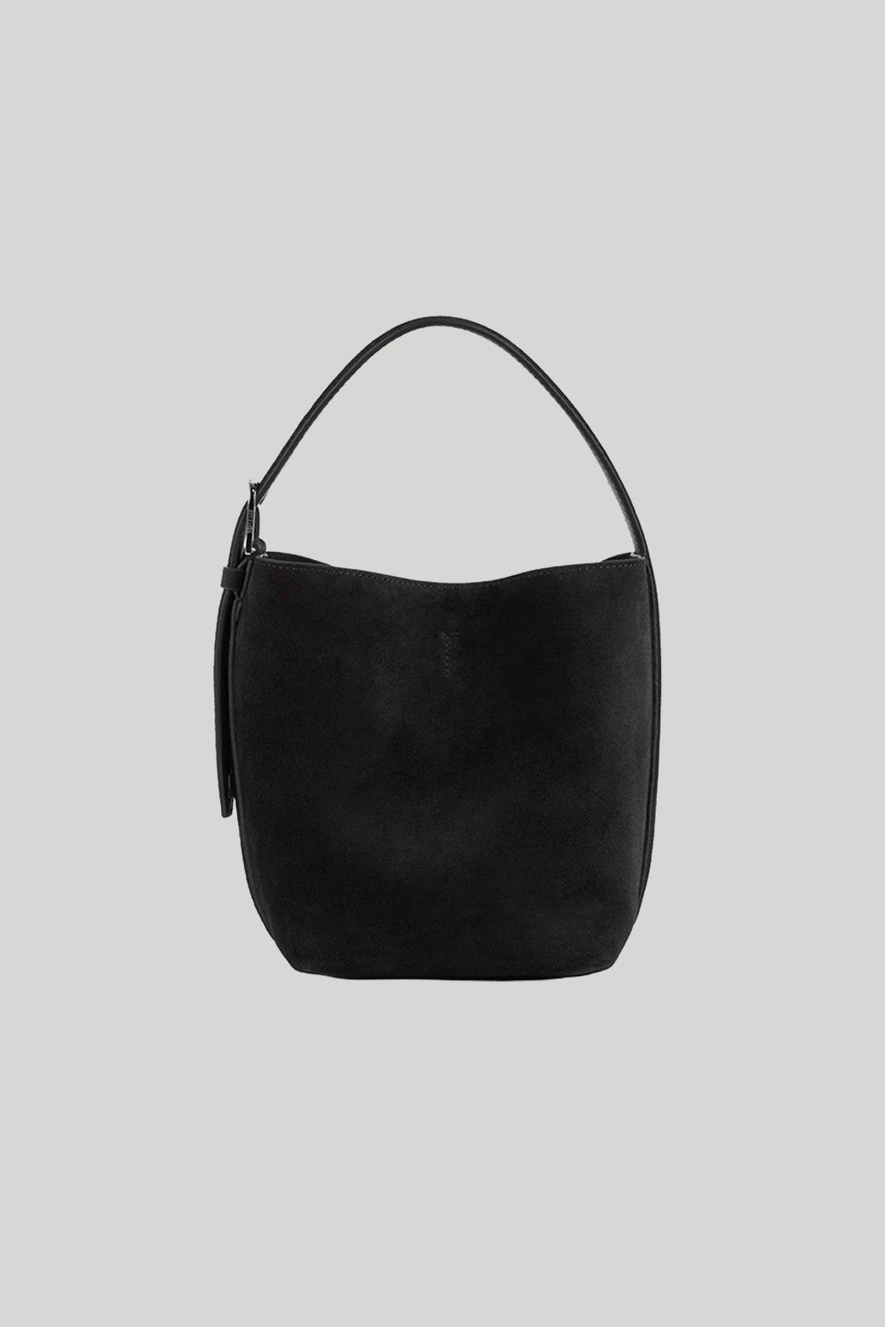A black suede crescent-shaped Toteme shoulder bag with a single top handle, shown against a solid light gray background. 