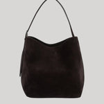 A dark brown suede hobo shoulder bag from Toteme with a single shoulder strap, shown against a solid light gray background.